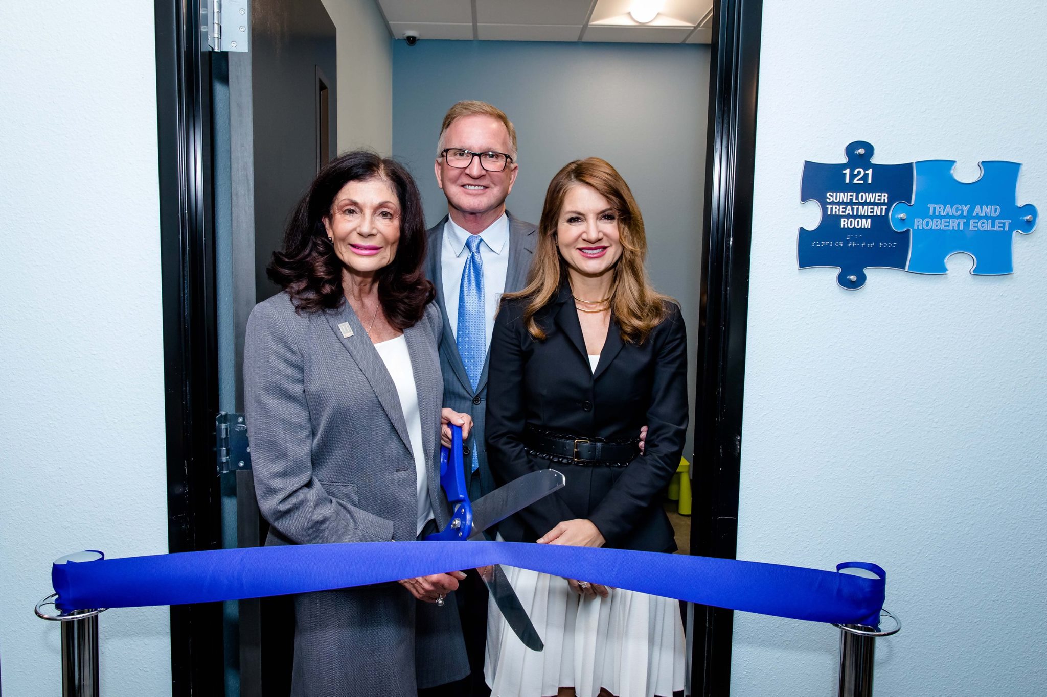 Robert Eglet, Tracy Eglet and Shelley Berkley in front of the Sunflower Treatment Room