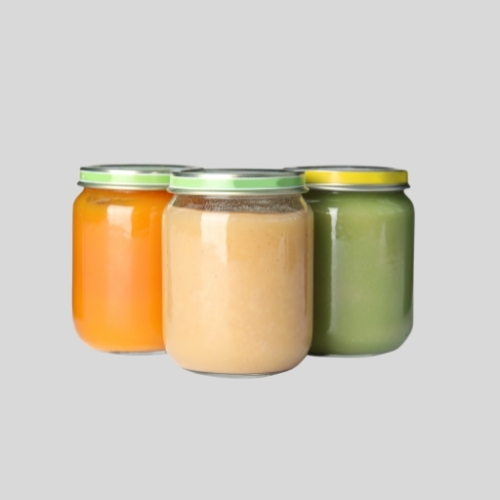 Three baby food jars with a grey background