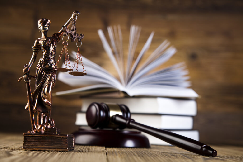 Statue lady justice with gavel in front of law books that belong to an Asian Personal Injury Lawyer Las Vegas, NV